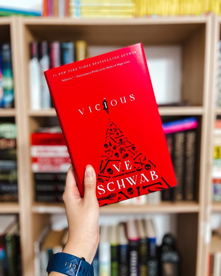 the red hardcover of vicious in front of a bookshelf